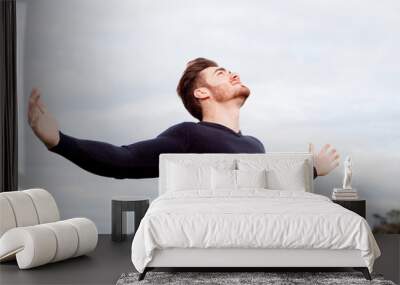 Handsome guy with open arms relaxed Wall mural