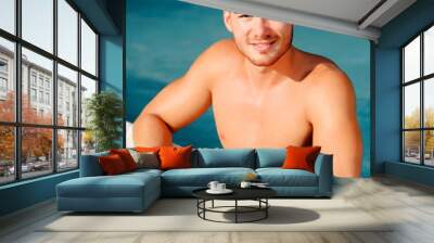 Handsome man in the pool relaxing Wall mural