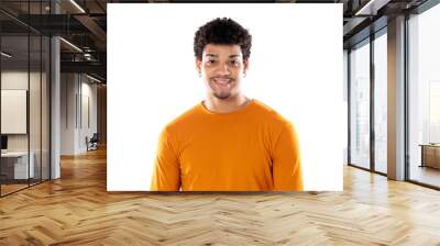 Smiling young man with afro hair wearing orange sweater Wall mural