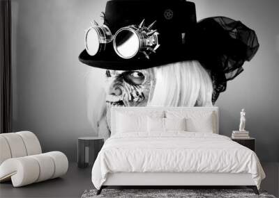 Woman with monster face and black hat wearing steampunk glasses Wall mural