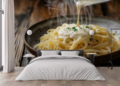 A bowl of pasta with a white sauce poured over it Wall mural