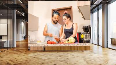 Pareja de mexicanos preparando ensalda en casa vida saludable Wall mural