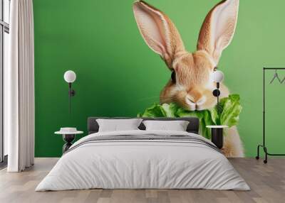 Fresh rabbit enjoying lettuce with vibrant green background Wall mural