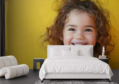 Adorable latin toddler smiling happy eating green apple looking to the camera over isolated yellow background : Generative AI Wall mural