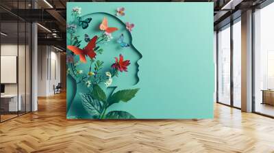 Cardboard silhouette of human head decorated with flowers and butterfly on mint background World mental health day concept Vertical banner Copy space : Generative AI Wall mural