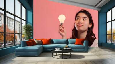 Closeup portrait of her she nicelooking attractive lovely sweet curious cheerful cheery smart clever girl creating new idea solution fantasize copy space isolated pink pastel color bac : Generative AI Wall mural