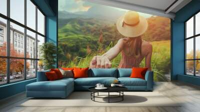 Follow me concept and traveling together Girl traveler wearing hat round straw bag and short jumpsuit holds the boyfriends hand and leading to green big mountains vacation : Generative AI Wall mural