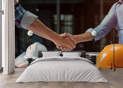 Generative AI : Architect engineer shaking hands other hand he is holding a helmet at construction site against clear sky With blueprint on table business teamwork cooperation success collaboration co Wall mural