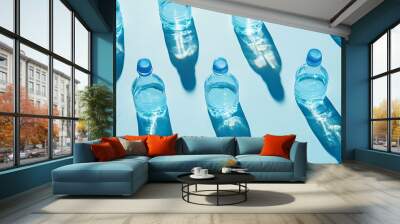 Minimal Pattern from Plastic bottles drinking water at sunlight with shadow on pastel blue aesthetic top view wide banner Pollution environmental protection Eco trend to reduce disposa : Generative AI Wall mural