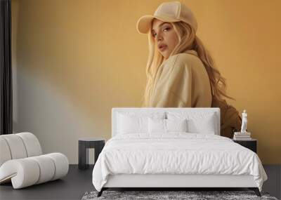 portrait of beautiful blonde girl dressed in beige oversized sweatshirt white sweatpants cap bag phone hangs over shoulder stylish fashion sports outfit lifestyle model : Generative AI Wall mural