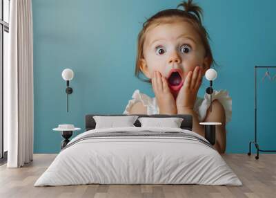 Portrait of surprised cute little toddler girl child standing isolated over blue background Looking at camera hands near open mouth : Generative AI Wall mural