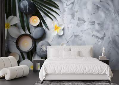 spa concept on white stone background palm leaves flower candle and zen like grey stones top view co Wall mural