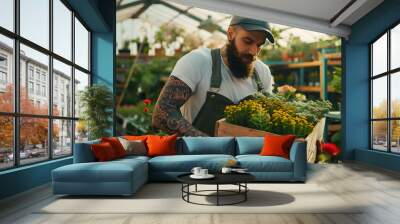 Tattooed bearded florist man working with flowers at a plant nursery and carrying them in a wooden crate Florist working in garden center Successful man gardener standing in a bright g : Generative AI Wall mural