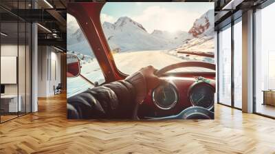 view from retro vintage car inside with part of interior gps screen with driver male hand on the steering wheel during bright snowy sunny day on straight ice road with snowy mountains  : Generative AI Wall mural