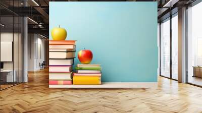 Stack of books and apple on a table. Back to school concept Wall mural