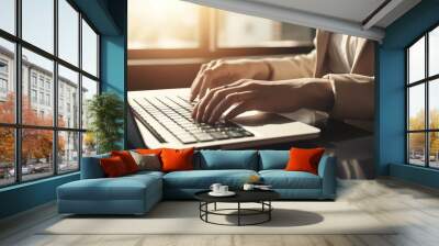 A woman is typing on a laptop computer Wall mural