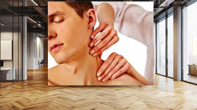 Shoulder and neck massage for man in spa salon. Doctor making therapy in rehabilitation center. Folded towels in the background. Massage the neck in an elite spa salon. Wall mural