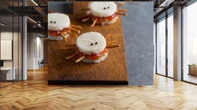 Spooky peanut butter and jelly sandwiches spiders for halloween on a cutting board Wall mural