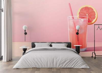 Refreshing pink Agua Fresca drink with ice, garnished with a slice of grapefruit and a straw, perfect for summer enjoyment. Wall mural