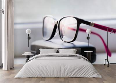 Glasses, white background, leather case Wall mural