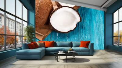 Cracked coconut on wooden table Wall mural