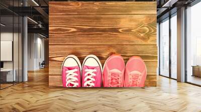 Pink sneakers on wooden texture Wall mural