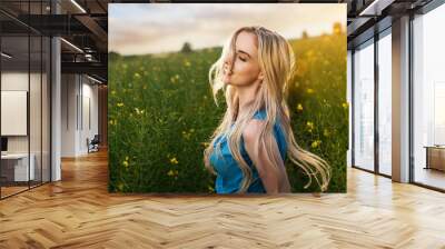 Young beautiful woman in the fields Wall mural