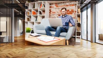 Young man with a laptop Wall mural