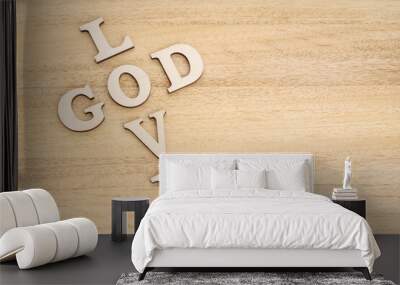 God is Love concept. Words forming a cross on wooden table Wall mural