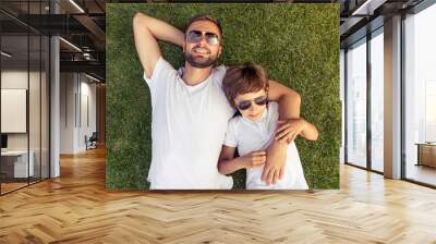 Dad and son resting outdoors Wall mural