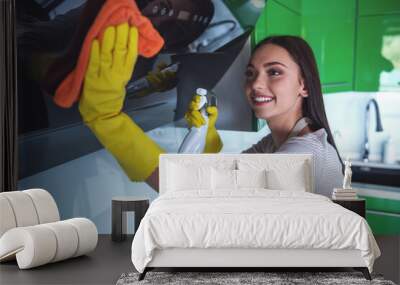 Woman cleaning her kitchen Wall mural