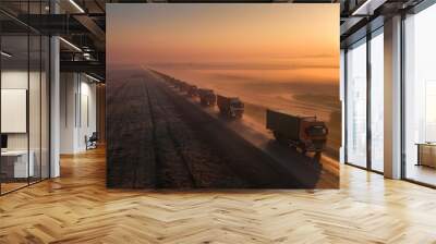 Aid convoy of trucks on a mission at dawn heading through a misty landscape Wall mural