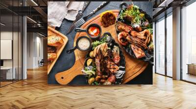 Assorted seafood on plates. Beautiful composition on a served seafood table, squid, shrimp, salmon steak and octopus. Food photo, low key, traditional Italian cuisine. Top view, save the space Wall mural