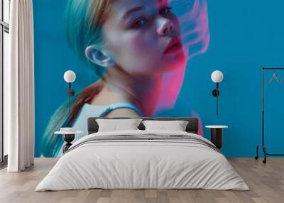 Beauty portrait of modern young girl wearing white top in pink neon light with long exposure. Nightlife, youth culture Wall mural