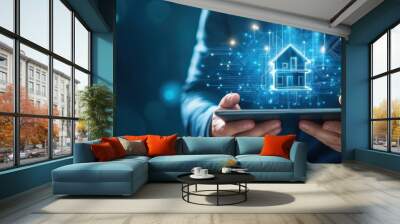 Businessman holding a tablet with a holographic house symbol representing real estate technology and innovation in the digital property market Wall mural