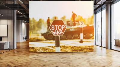 Creative Badge - Stop Wars. Concept - no war, stop military operations, world peace. Stop war sign on the background of military equipment. Wall mural