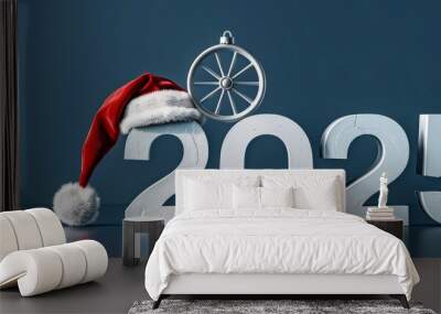 Festive 2025 holiday scene with Santa hat and car wheel decoration on a dark background Wall mural