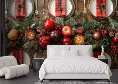 Festive table setting featuring red and burgundy decor with apples, pine cones, and holiday greenery Wall mural