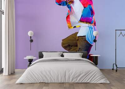 Guy dancing contemporary dance in studio. Neon light grey background. Acrobatic bboy dancer. Break dance lessons. Wall mural