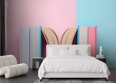 Open book on a pastel pink and blue background emphasizing minimalism and creativity Wall mural