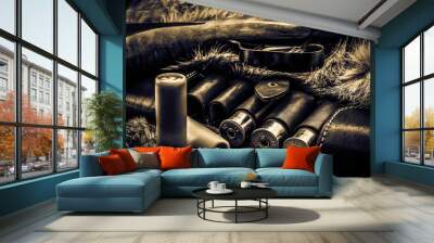 12 caliber bullets in leather hunting bandolier and hunting rifle lying on the fur of the animal. View close-up Wall mural