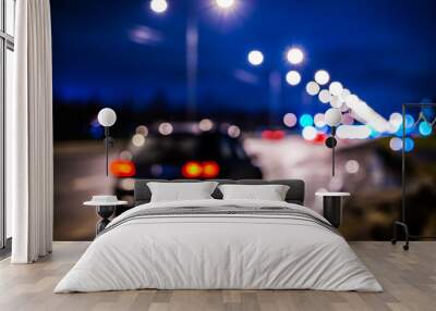 Rainy night in the big city, the big black car parked on the roadside. Defocused image Wall mural