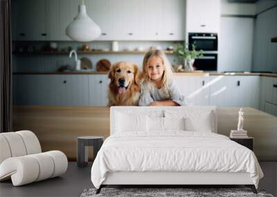 Teenage girl is preparing for breakfast at the kitchen table with a golden retriever dog in the kitchen. Cute baby and dog from home. Wall mural