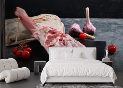 Thigh of lamb meat on a dark background, grocery delivery, copy space. Wall mural