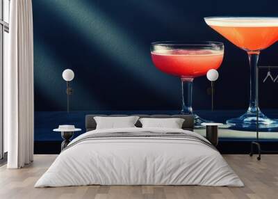 Two elegant glasses of pink cocktail drinks beautifully showcased in creative lighting on a stylish bar countertop Wall mural