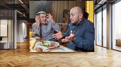 two men in a restaurant arguing during lunch Wall mural