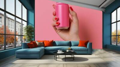 Woman holding a pink soda can against a matching pink background Wall mural