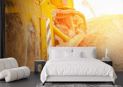 Yellow Excavator in the rays of sunlight. Close-up side view. Wall mural