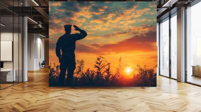 A silhouette of a soldier saluting the sunset with the American flag flying in the background, veteran's day Wall mural