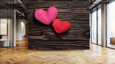 Two woolen handmade hearts on the dark brown wooden boards Wall mural